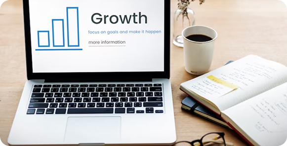 A group meeting around a table with papers and laptops shows a digital overlay of tech icons such as gears and a globe, symbolizing teamwork and innovation.